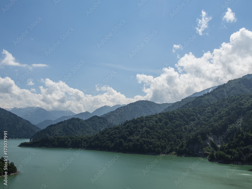 view of the river and forests on the mountain on blue sky with cloud background