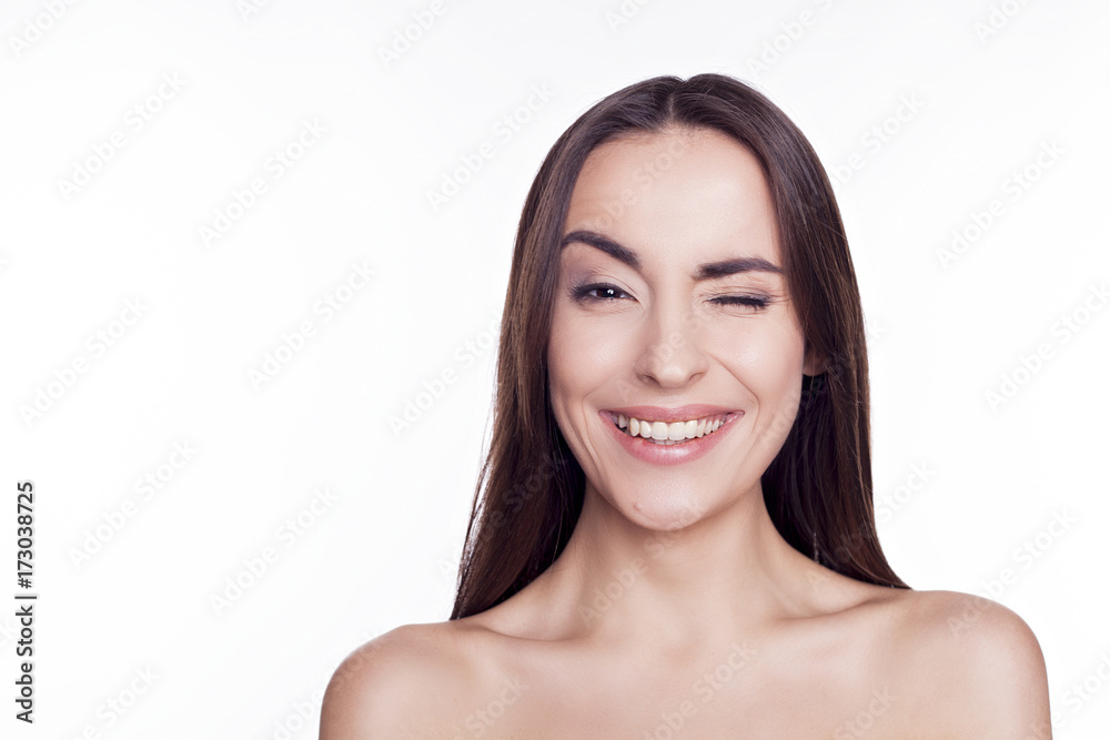 Attractive brunette winks at the camera and smiling isolated. Attractive brunette winks at the camera and smiling isolated.