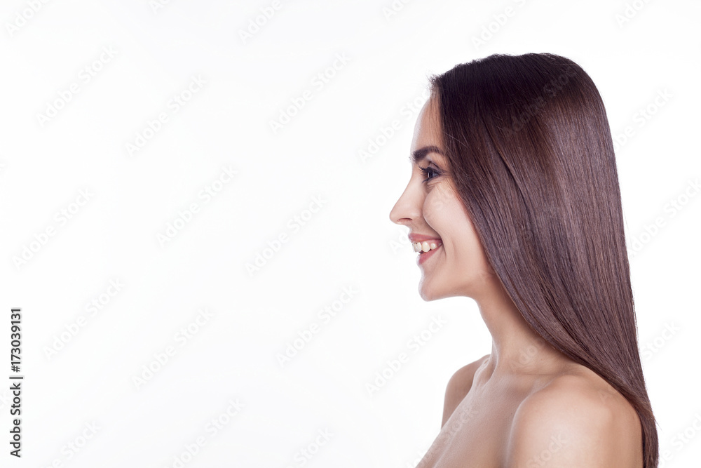Side portrait of an attractive confident smiling young woman. Side portrait of an attractive confident smiling young woman.