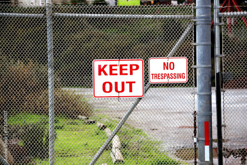 keep out no trespassing sign at the fence