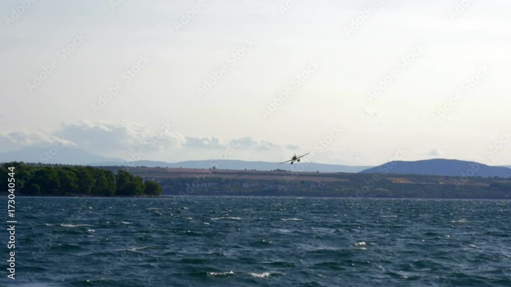 Fire fighting airplane going for new water at sea between islands. In slow-motion hd. Fire fighting airplane going for new water at sea between islands. In slow-motion hd.