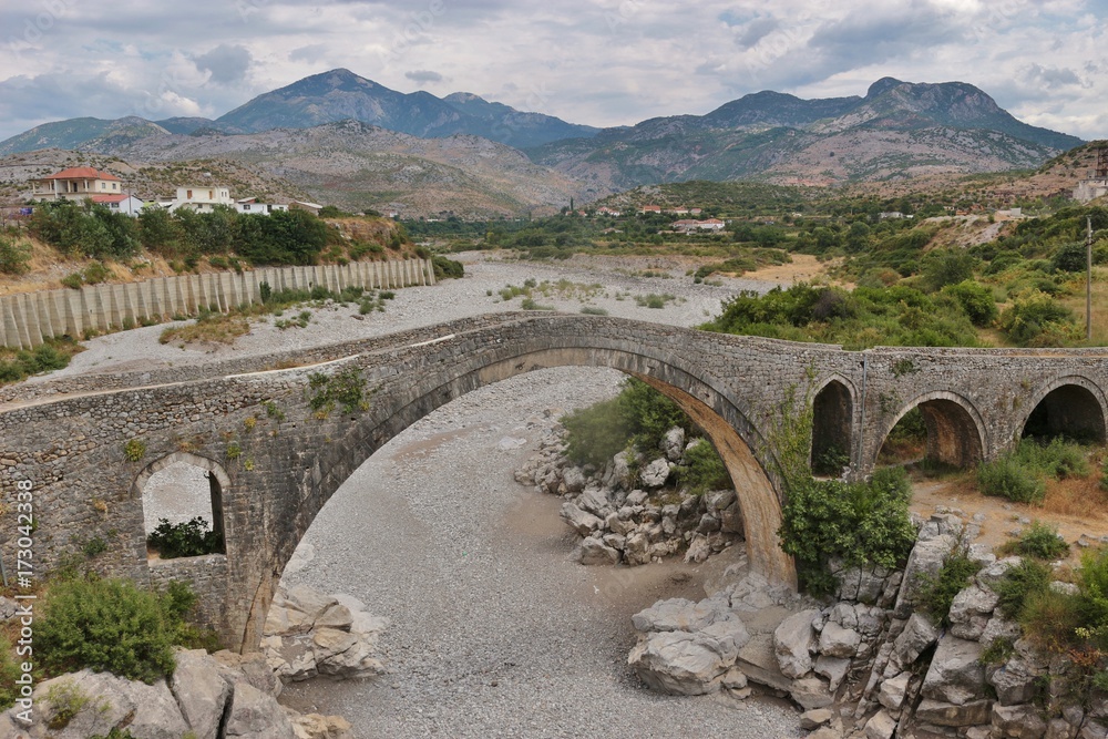 The Mesi bridge in Mes, Albania, near Shkoder. An old stone bridge built by the Ottomans in 1770, now a tourist attraction. North Albania, Southeast Europe.