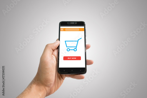 Online shopping sceen on phone background. Smartphone with cart. photo