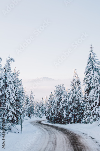 Curvy snow covered road winding through the mountains.