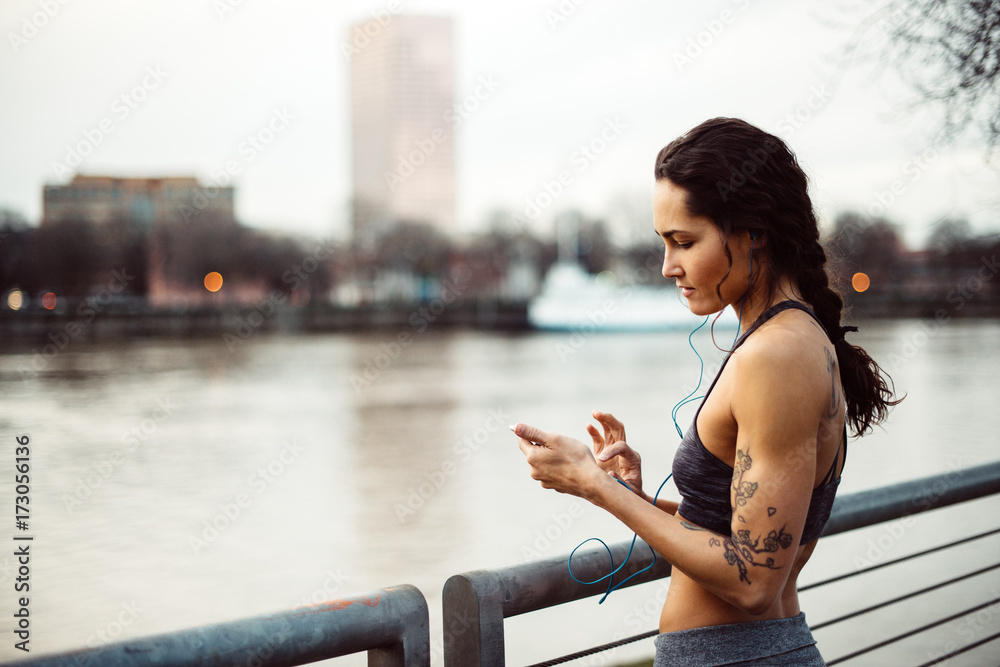 Young athletic woman working out by the waterfront at dusk Young athletic woman working out by the waterfront at dusk