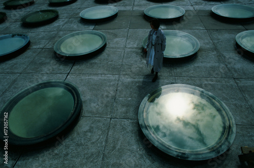 A film photo of young woman staying on the strange rooftop