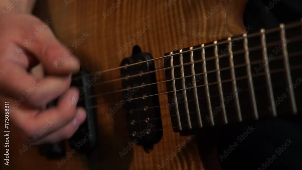Playing guitar / Rock musician plays solo guitar. Close up of rock guitar solo. Closeup of rock guitar player hands. Rock guitarist. Young man playing electric guitar Playing guitar / Rock musician plays solo guitar. Close up of rock guitar solo. Closeup of rock guitar player hands. Rock guitarist. Young man playing electric guitar