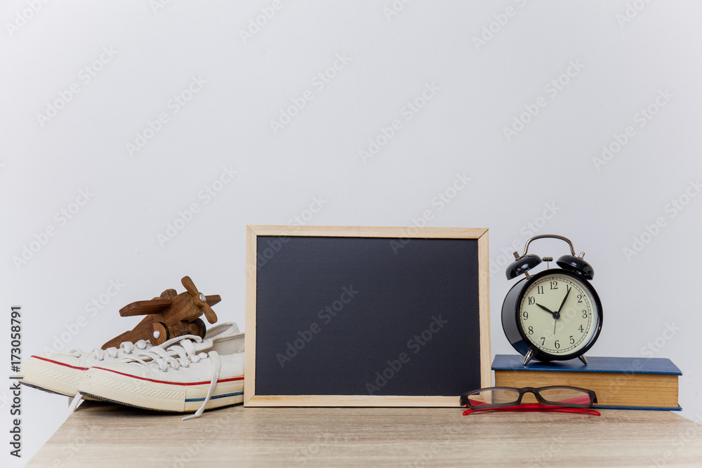 mock up of travel stuff and black board on table