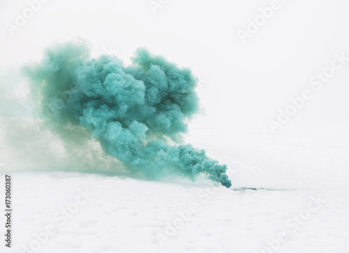 green smoke on the white snow photo