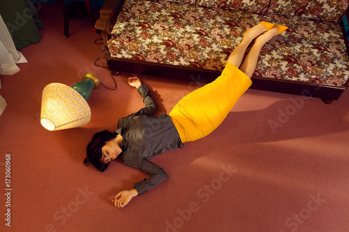depressed young woman lies down on the floor