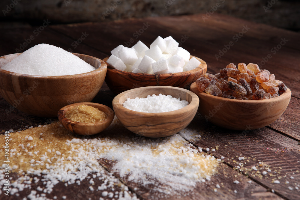 Fototapeta premium Various types of sugar, brown sugar and white on wooden table
