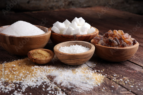 Various types of sugar, brown sugar and white on wooden table