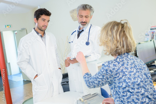 two doctors and patient in medical cabinet