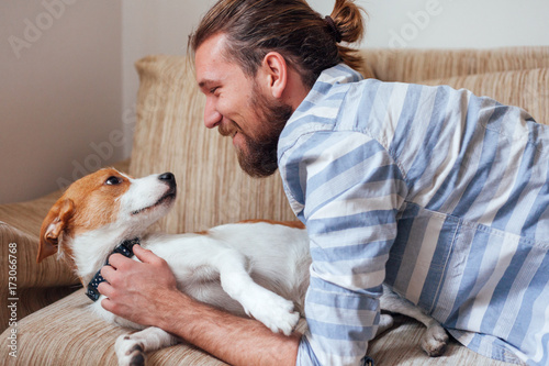 Man having fun with his jack russell dog