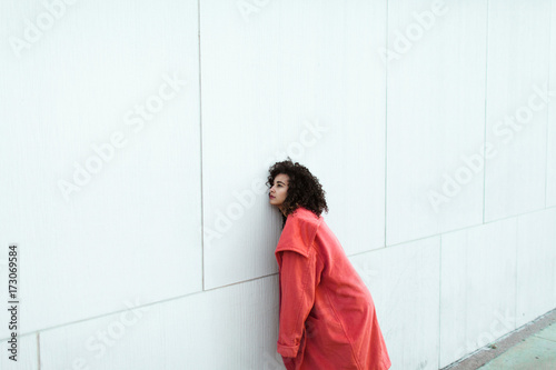 Young woman in a pink coat