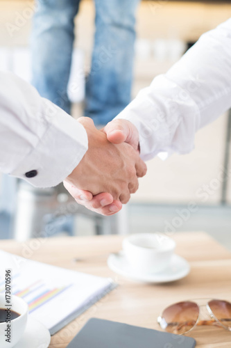 Welcome to board! Asian business people shaking hands with colleagues together at meeting time for develop job to success during discussing document about finance on table at meeting time, business co