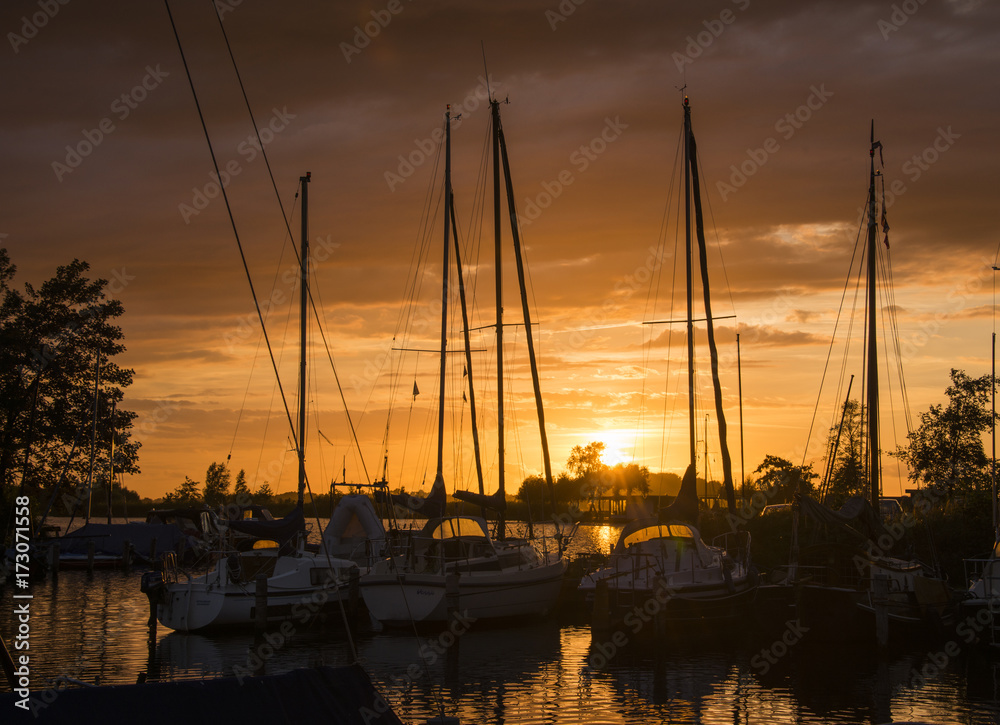 sunset in the harbor of de veenhoop in holland