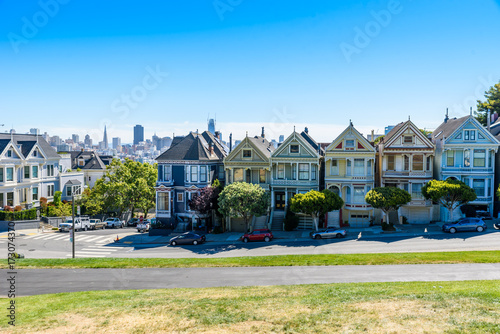 Beautiful view of Painted Ladies, colorful Victorian houses located near scenic Alamo Square in a row, on a summer day with blue sky, San Francisco, California, USA