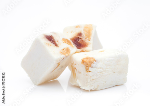 Nut nougat bar traditional sweet candy on white photo
