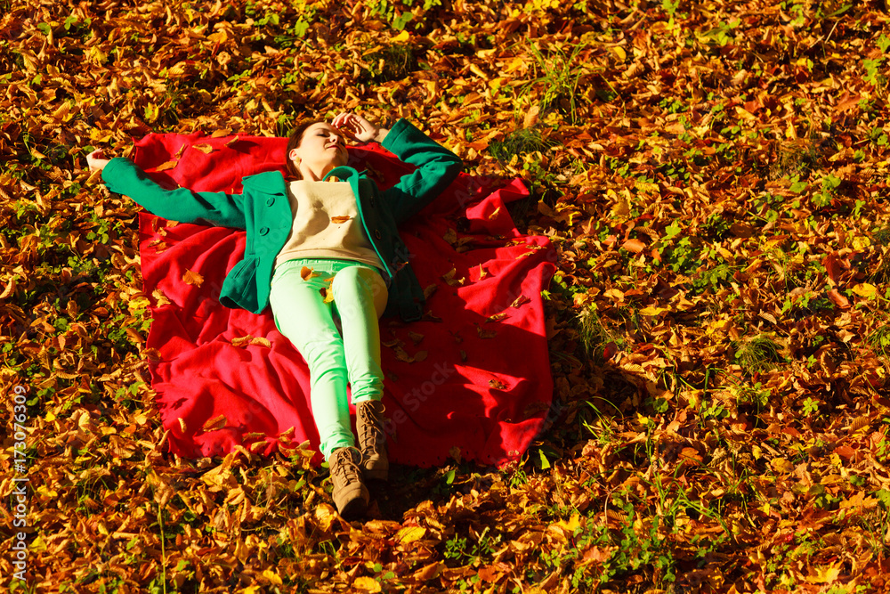 Woman sitting on autumnal leaves Woman sitting on autumnal leaves