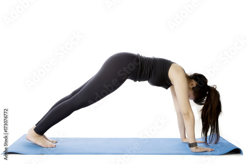 Young woman doing an exercise on studio