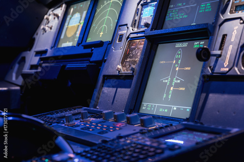 Detailed view of the upper set of switches in a large airliner. Selective focus. Low Light from a plane control cockpit in the dark vintage, detail on the interior cockpit photo