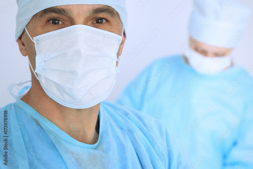 Boss surgeon is examining the operation while medical team are busy of patient. Medicine, healthcare and emergency in hospital Boss surgeon is examining the operation while medical team are busy of patient. Medicine, healthcare and emergency in hospital