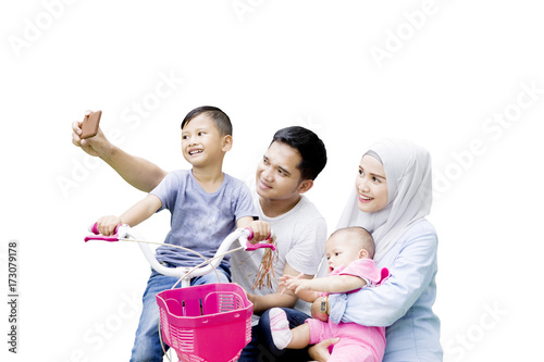 Muslim family takes a picture together on studio photo