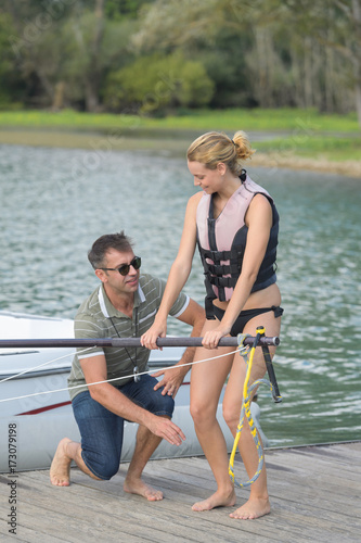 happy young girl learning water skiing