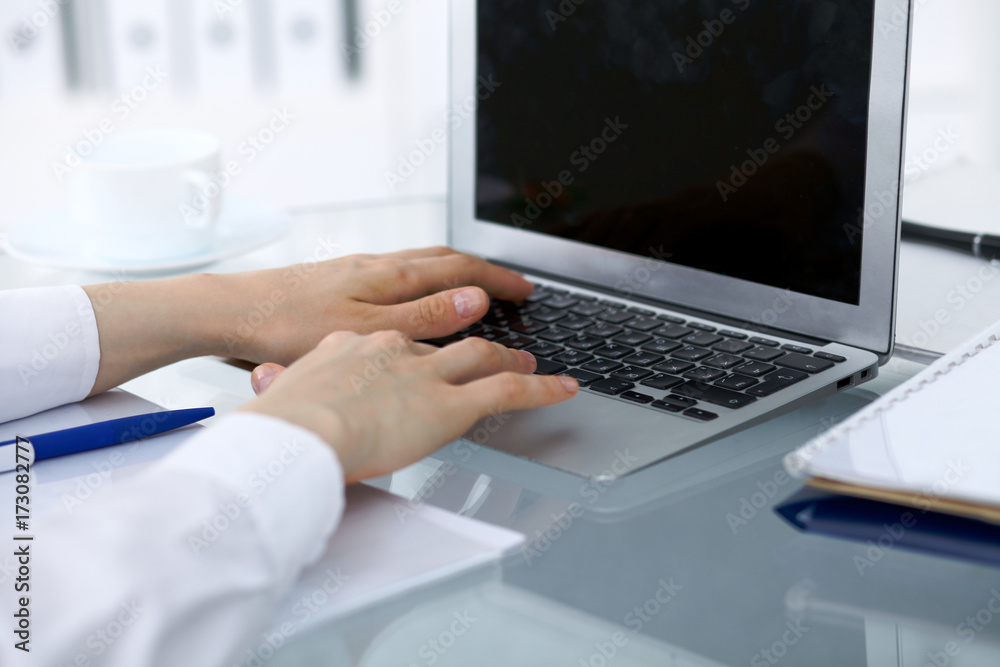 Close up of business woman hands typing on laptop computer Close up of business woman hands typing on laptop computer