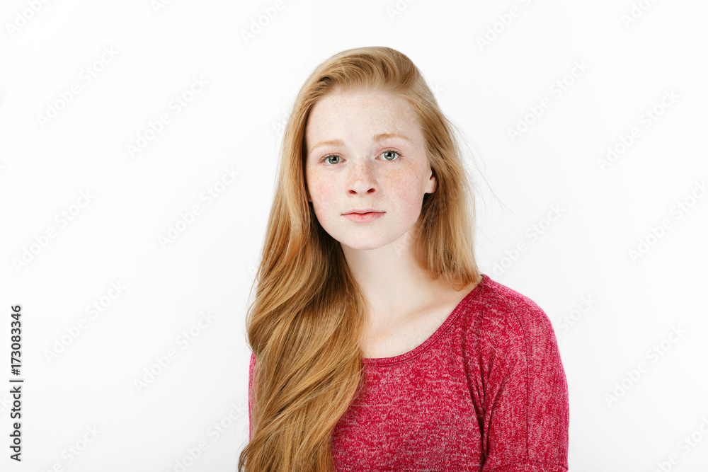 Beauty portrait of young adorable fresh looking redhead woman with gorgeous extra long hair. Emotion and facial expression concept. Beauty portrait of young adorable fresh looking redhead woman with gorgeous extra long hair. Emotion and facial expression concept.