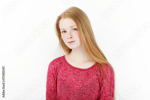 Beauty portrait of young adorable fresh looking redhead woman with gorgeous extra long hair. Emotion and facial expression concept.