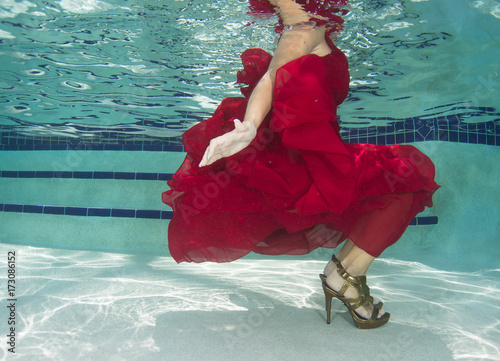 Woman in a red dress underwater