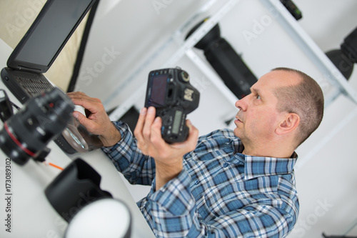 technician repairing digital camera in a service laboratory © auremar