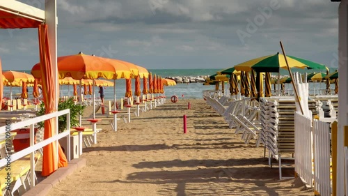 sand and umbrellas on the beach of gabicce, in Italy photo