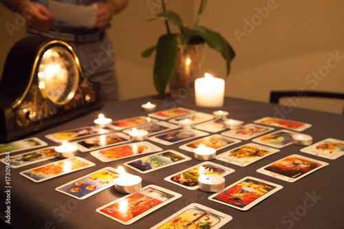 Mystic fortune-telling with fired candles and playing cards in d