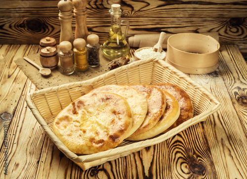 Traditional Georgian bread - khachapuri and Kolkh khachapuri on the table.Homemade baking. Flat lay, overhead.Khachapuri with cheese,georgian khachapuri megruli with cheese,Traditional Georgian pie photo