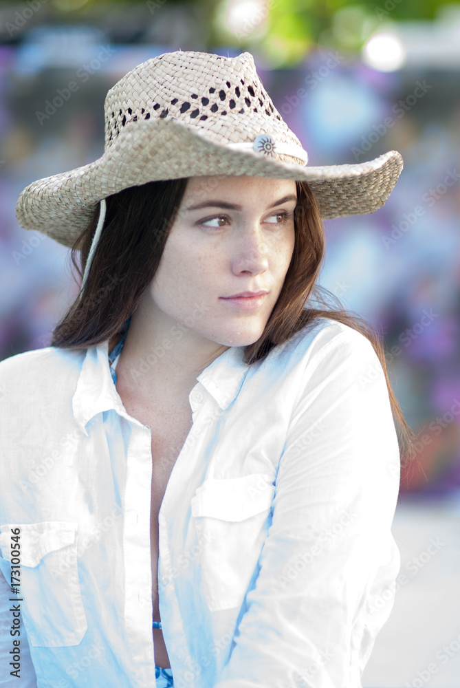 Woman wearing a white shirt and swimsuit. Woman wearing a white shirt and swimsuit.