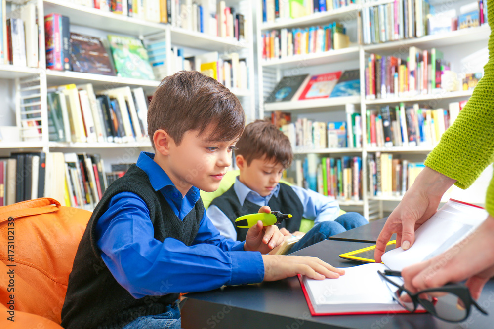 Teacher and children at school library Teacher and children at school library