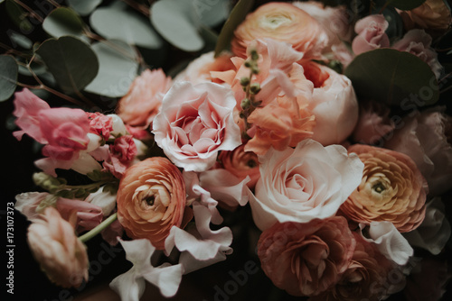 Pink and coral garden rose, ranunculus and eucalyptus bouquet