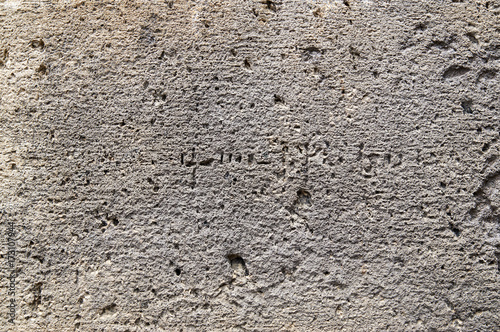 Background with texture of ancient stone wall of armenian monastery Geghard