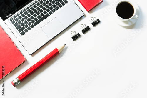 Fotografija Office workplace with laptop, cup of coffee, red accessories on white
