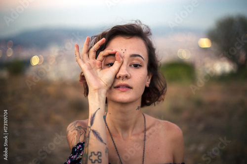 Tattooed alternative girl gesturing photo
