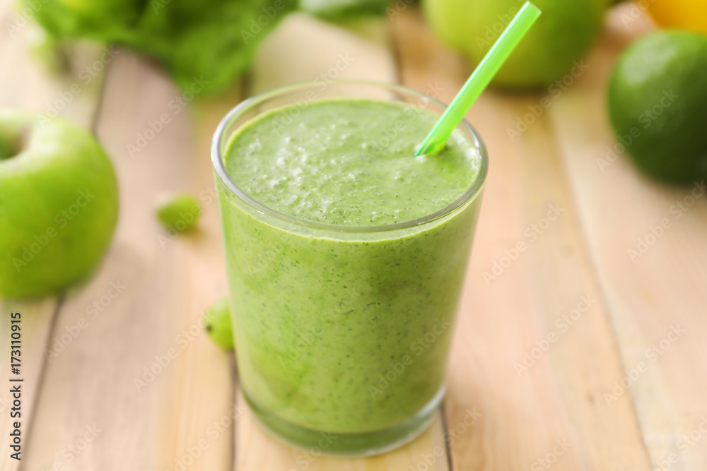 Healthy smoothie with kale in glass on wooden table Healthy smoothie with kale in glass on wooden table