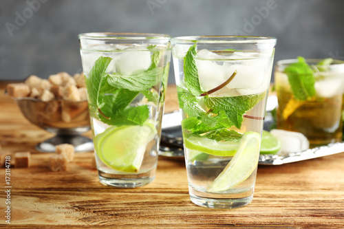 Two glasses with mint julep on wooden table