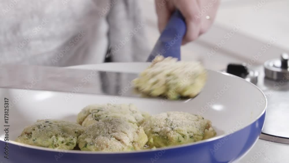 Close up, chef flips tuna cakes with spatula Close up, chef flips tuna cakes with spatula