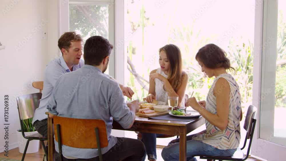 Group Of Friends Enjoying Dinner Party At Home Together Group Of Friends Enjoying Dinner Party At Home Together