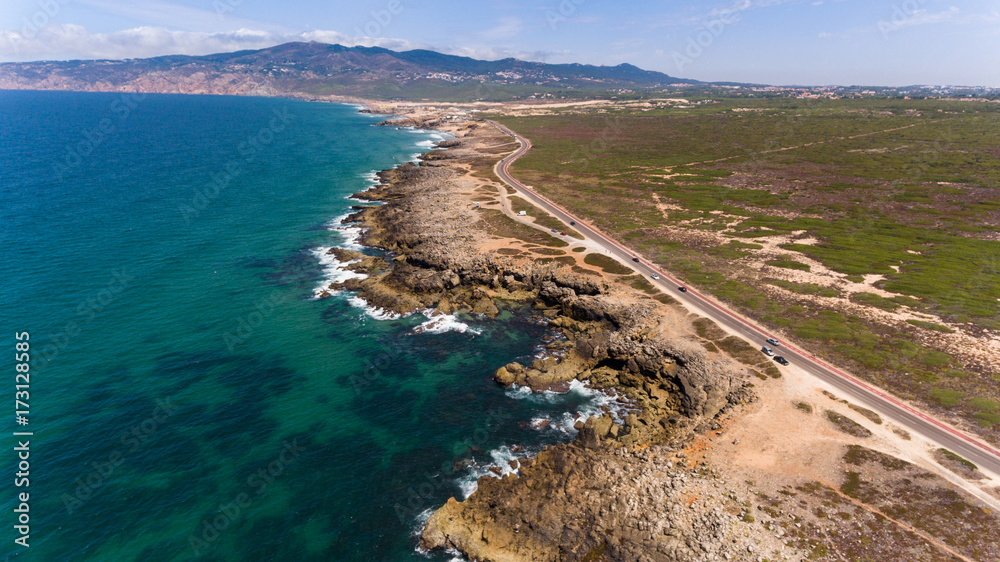 Fototapeta premium Stunning road along the beautiful coast of the Atlantic Ocean in Portugal. aerial view from Drone