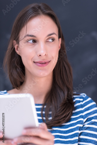 woman using tablet in front of chalk drawing board