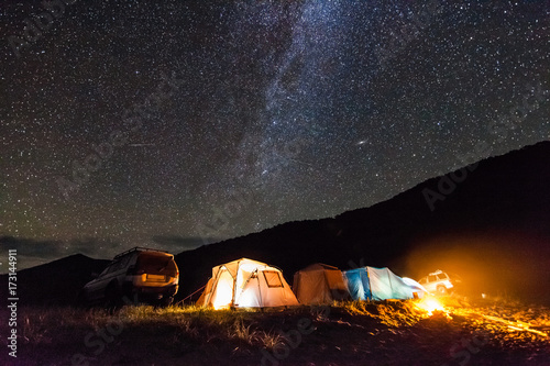 Tourist camping at sea coast at night